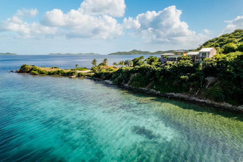 a body of water with houses and trees